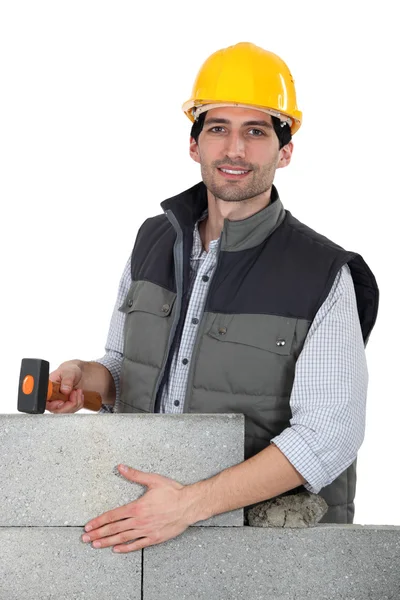 Builder hammering wall — Stock Photo, Image