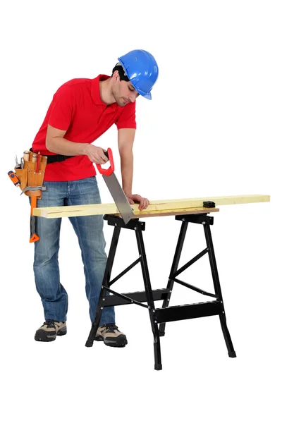 Carpenter sawing plank isolated on white — Stock Photo, Image