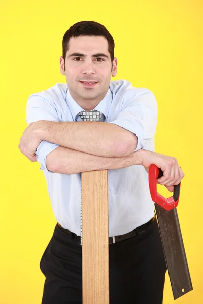 Businessman stood with hand-saw — Stock Photo, Image