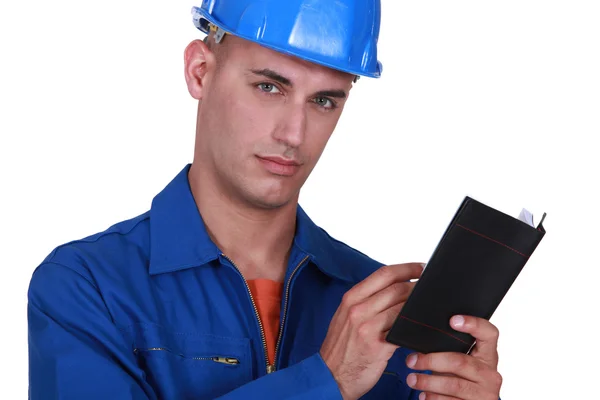 Plumber writing in appointment book — Stock Photo, Image
