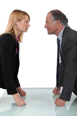 Businessman and businesswoman having a quarrel clipart