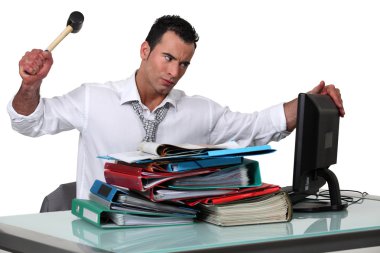 Man threatening computer with hammer clipart