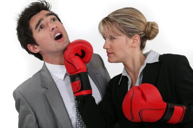 Woman punching her colleague clipart