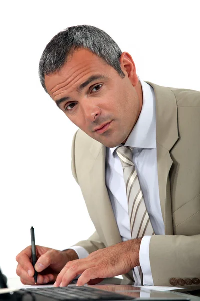 Attentive businessman making notes — Stock Photo, Image