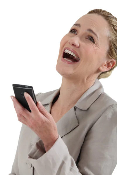 Female executive laughing at cellphone — Stock Photo, Image