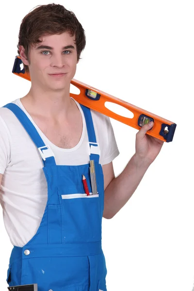 Young man with a spirit level — Stock Photo, Image