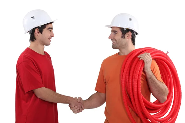 Two electricians shaking hands — Stock Photo, Image
