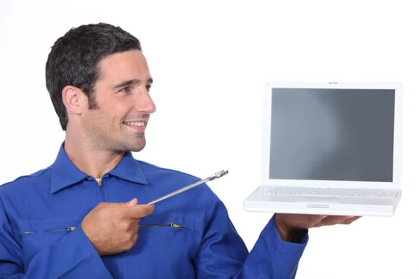 Man with a spanner and laptop computer — Stock Photo, Image