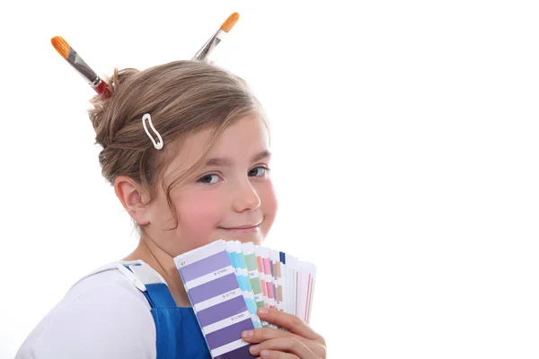 Young girl holding a selection of colour samples — Stock Photo, Image