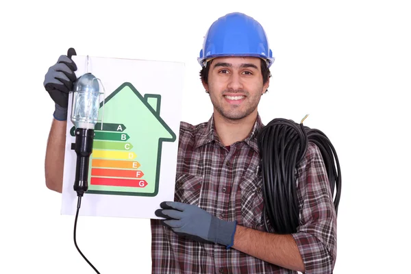An electrician showing energy class chart — Stock Photo, Image