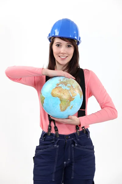 Tradeswoman holding a globe — Stock Photo, Image