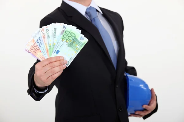 Real estate businessman holding money in cash — Stock Photo, Image