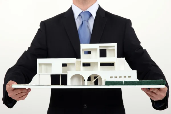 Architect holding scale replica of building — Stock Photo, Image