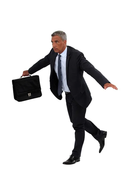 Senior businessman walking on a tight-rope — Stock Photo, Image