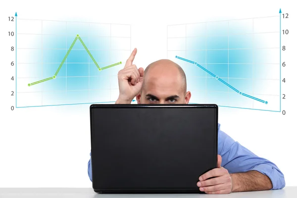 Businessman with a laptop and graphs — Stock Photo, Image