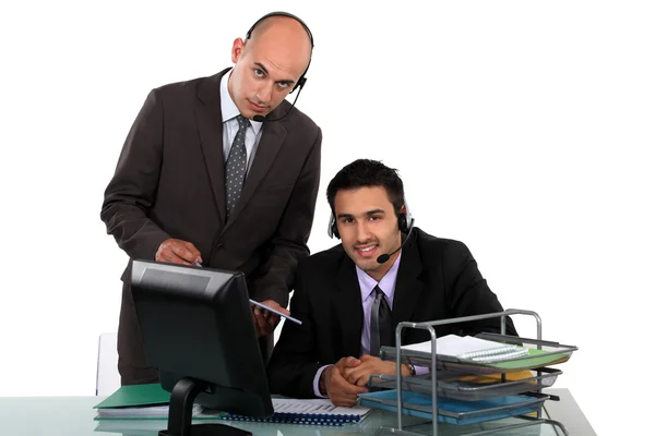 Businessmen wearing headsets Royalty Free Stock Photos