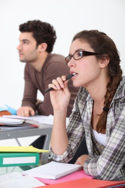 Two students concentrating in class clipart