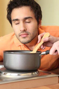 Man smelling stew clipart