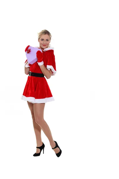 Attractive woman dressed as Mrs. Claus and holding a heart-shaped box — Stock Photo, Image