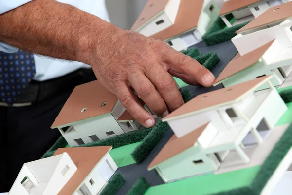 Man with a model of a housing estate — Stock Photo, Image