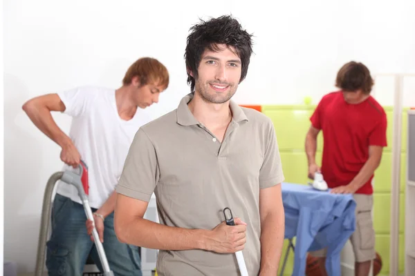 Three male housemates cleaning — Stock Photo, Image