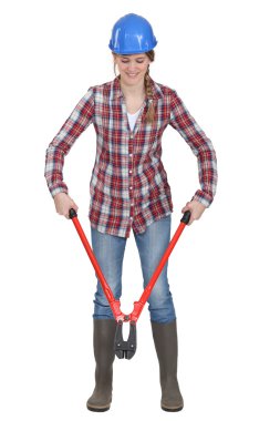 Woman using pair of bolt-cutters clipart