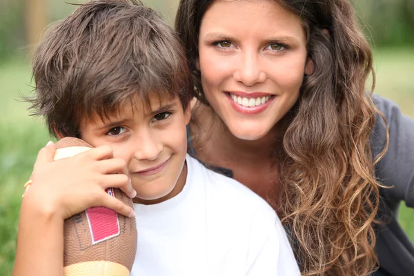 Little boy holding American football — Stock Photo, Image