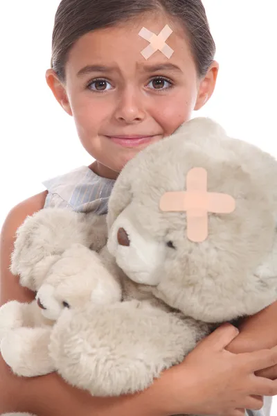 Little girl and teddy bear injured — Stock Photo, Image
