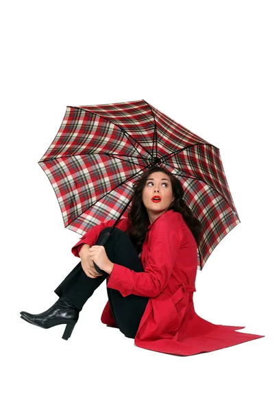 Красивая женщина в красном пальто и зонтике — стоковое фото