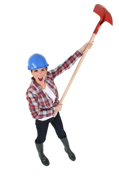 Woman yelling with a shovel in hands — Stock Photo, Image