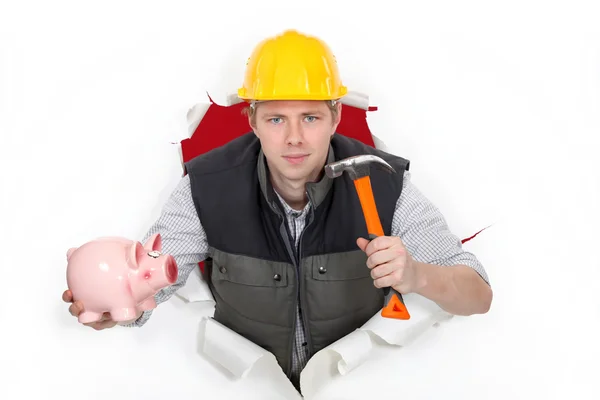 Arbeiter mit Hammer und Sparschwein — Stockfoto