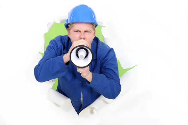 Stock image A manual worker with a megaphone.