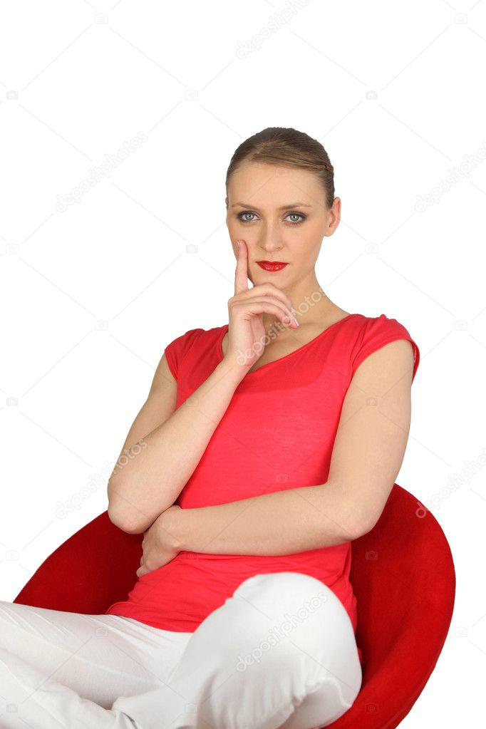 confident woman in a red chair