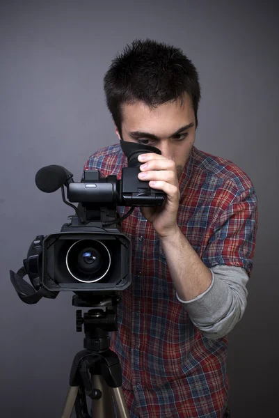 Young man with professional video camcorder — Stock Photo, Image