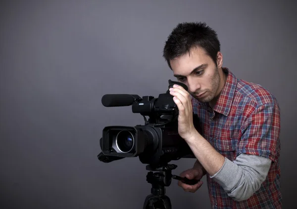 Junger Mann mit Videokamera Stockbild