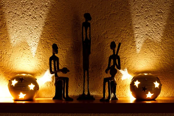 Three African figurines and tambourine — Stock Photo, Image