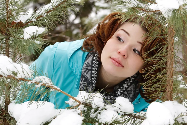 Portrait of a young girl on a background of a winter forest — Stock Photo, Image