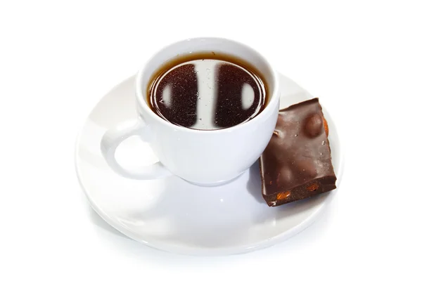 Tasse Kaffee mit einem Stück Schokolade Stockbild