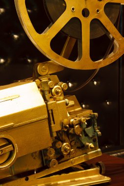 Antique gold color projector with the film clipart