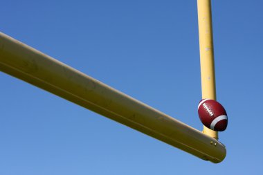 Football kicked through the Goal Posts clipart