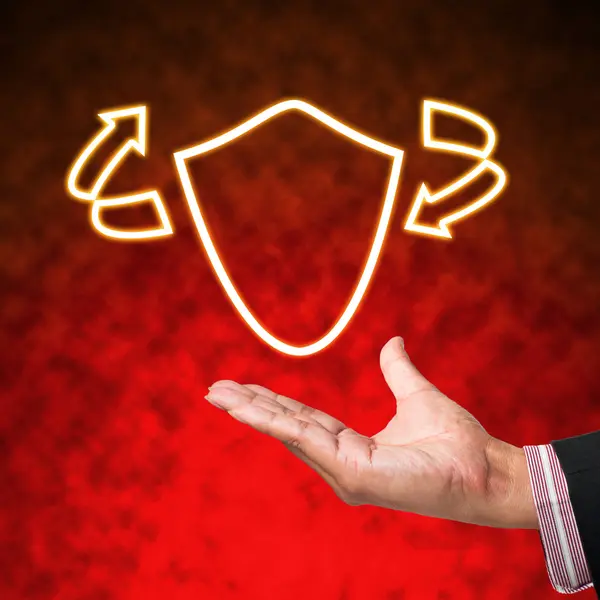 Icon of shield with business hand on abstract background — Stock Photo, Image