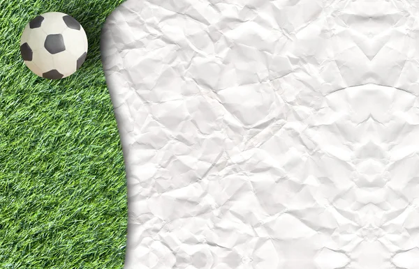 Plastelina piłki nożnej na papier i trawa tło — Zdjęcie stockowe