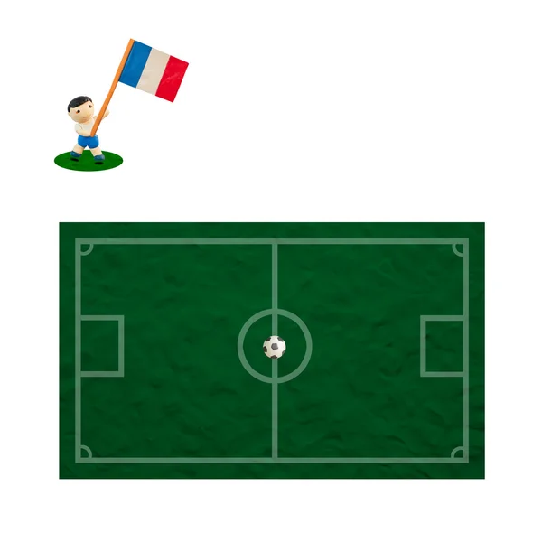 Пластиковый футбол с флагом на травяном и бортовом фоне — стоковое фото