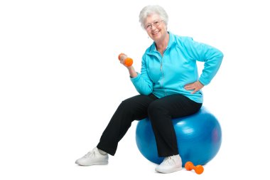 Senior woman working with weights in gym clipart