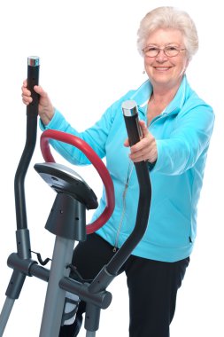 Senior woman exercising on stepper clipart