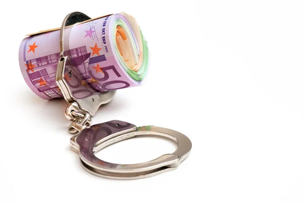 Money and handcuffs — Stok fotoğraf