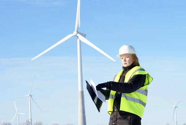 Engineer or architect with white safety hat and wind turbines on — Stock Photo, Image