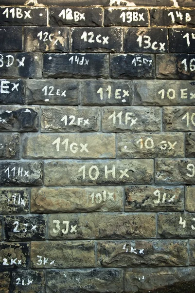 Textura de pared de piedra con números — Foto de Stock