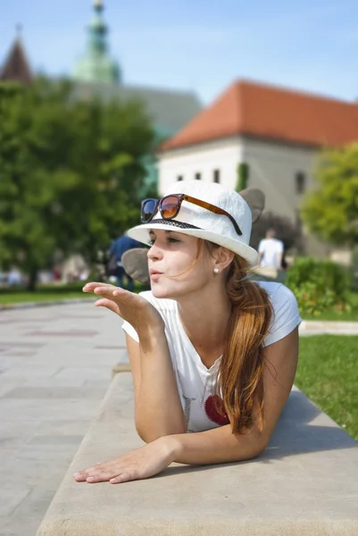 Portrait of a cute young female blowing a kiss, outdoors — Stock Photo, Image