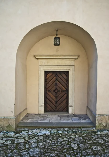 Old entrance with lamp in castle — Stock Photo, Image